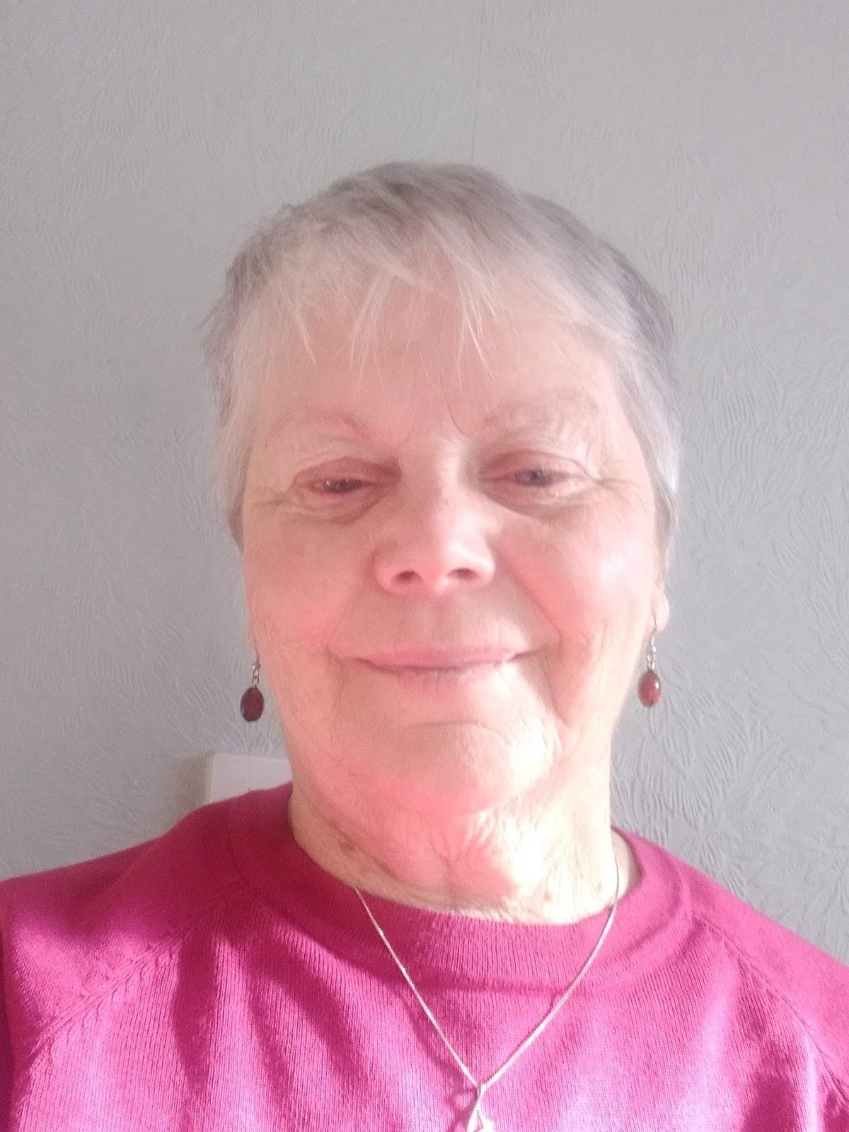 A photograph of Marie smiling at the camera.